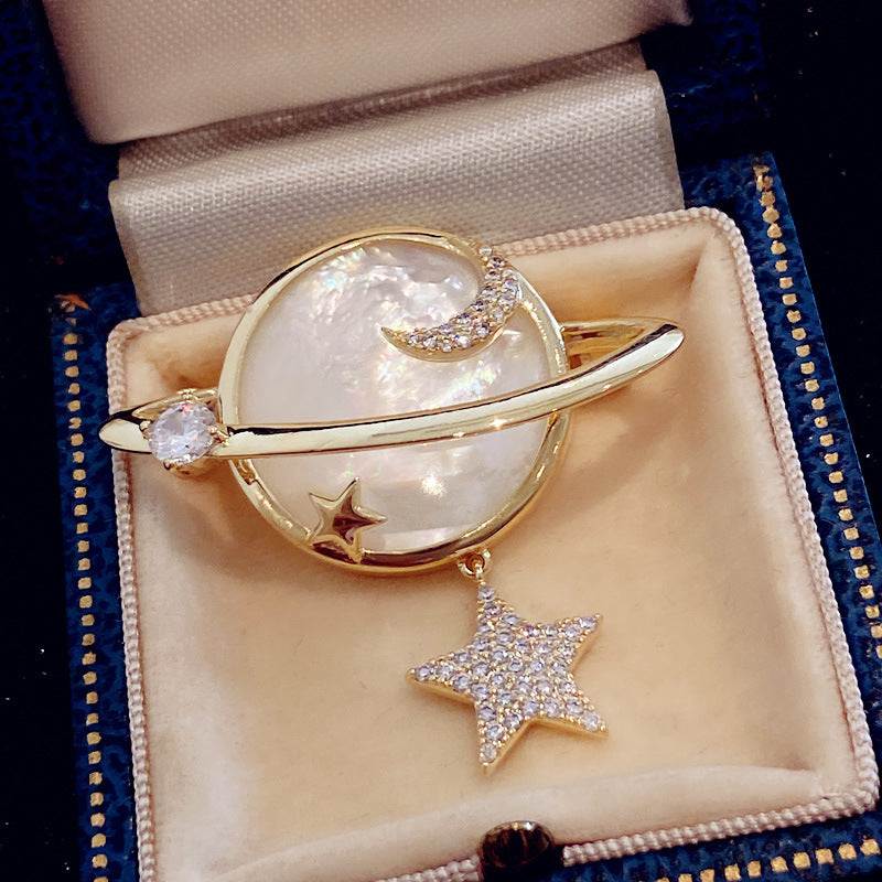 Mother of pearl planet brooch with zircon accents
